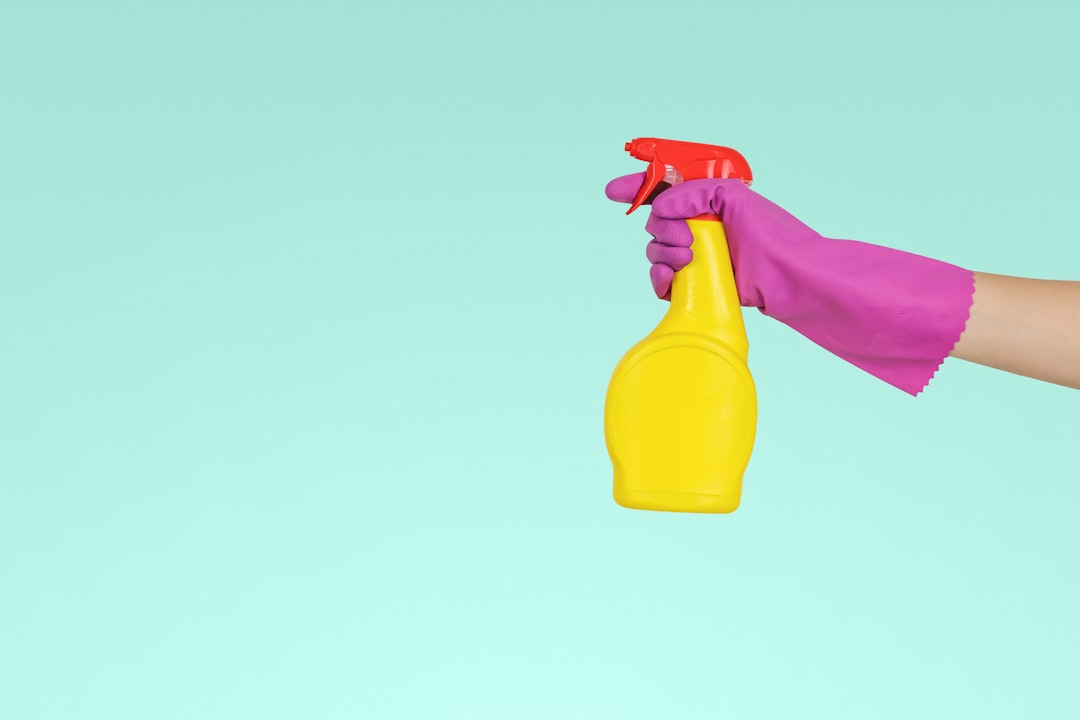 services-08 person-holding-yellow-plastic-spray-bottle-zmnefoi3k